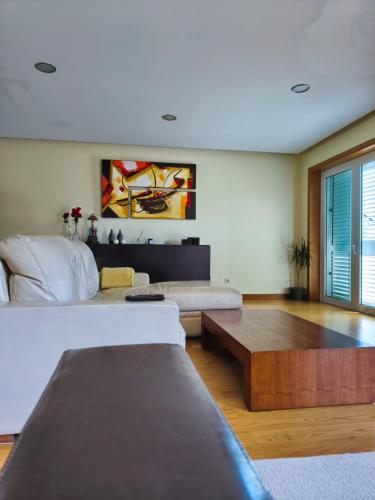 a living room with a couch and a coffee table at 2 Floors Villa Close Apulia Beach in Esposende