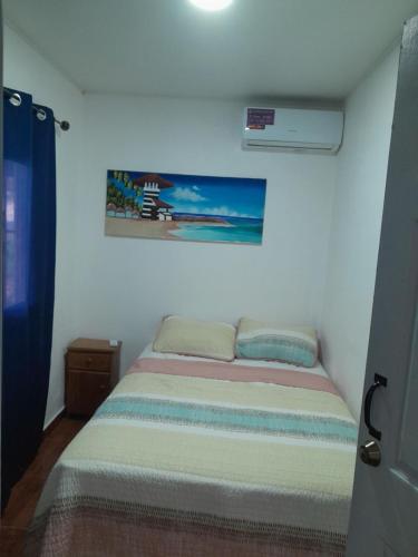 a bedroom with a bed in a room at Beachfront House In Isla Grande Province of Colon in Portobelo
