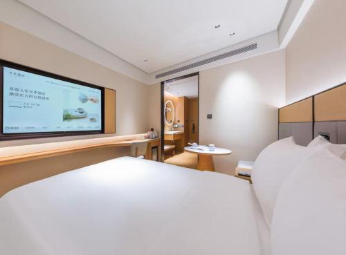 Ένα ή περισσότερα κρεβάτια σε δωμάτιο στο JI Hotel Beijing West Railway Station North Square
