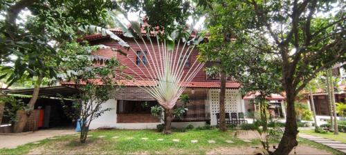 a house with a large white fan hanging from it at Banksy's Siem Reap in Phumĭ Réach Born