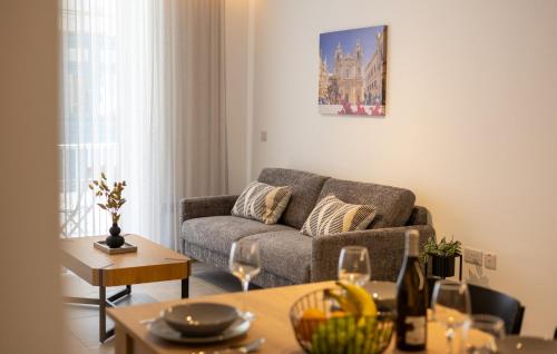 a living room with a couch and a table at Downtown Central Apartments in Msida
