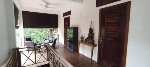 a room with a staircase and a door and a balcony at Banksy's Siem Reap in Phumĭ Réach Born