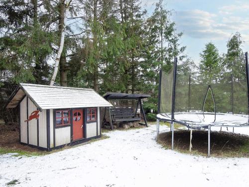 a play structure and a playground with a swing at 6 person holiday home in Fårvang-By Traum in Fårvang