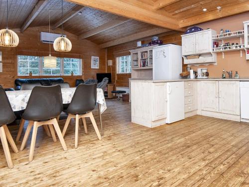 a kitchen with a table and chairs in a room at 6 person holiday home in Fårvang-By Traum in Fårvang
