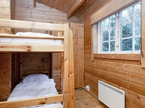 a wooden cabin with two bunk beds in it at 6 person holiday home in Fårvang-By Traum in Fårvang