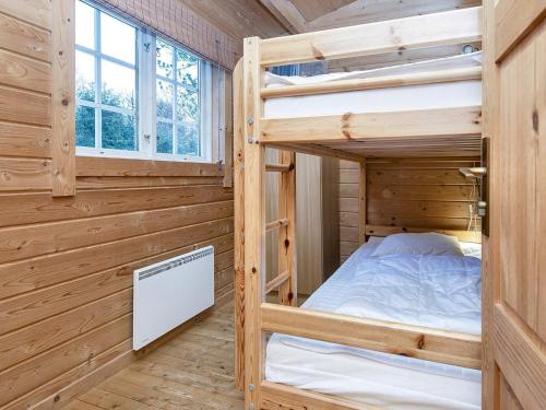 a bedroom with two bunk beds in a log cabin at 6 person holiday home in Fårvang-By Traum in Fårvang