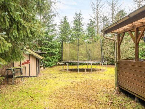 a basketball hoop in a yard with a tent at 6 person holiday home in Fårvang-By Traum in Fårvang