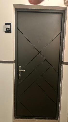 a black garage door with a silver handle at Luna Home in Jermuk