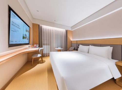 Ένα ή περισσότερα κρεβάτια σε δωμάτιο στο JI Hotel Beijing West Railway Station North Square