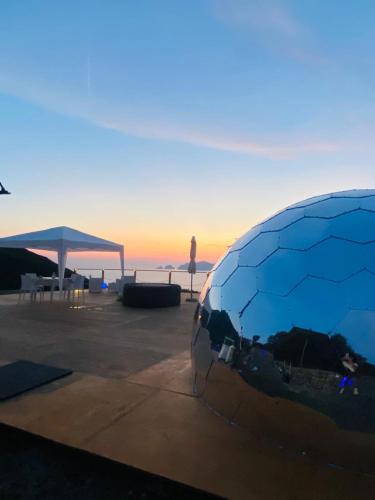 a view of the ocean with a sculpture in the foreground at Palmaria Sky Bubbles Room in Ponza