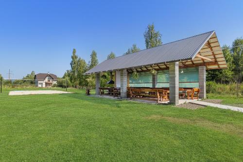 a gazebo with a roof on a grass field at Fazenda Akwa Baseini in Solotvyno
