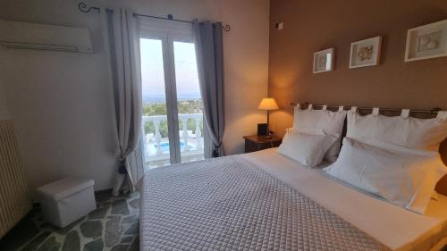 a bedroom with a bed and a window with a view at Mediterranean Villa Megara in Megara