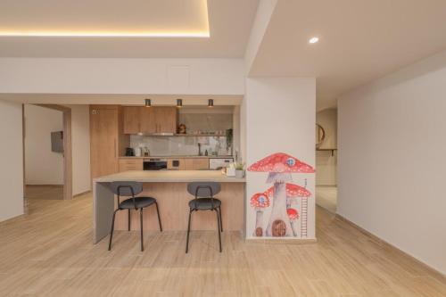 a kitchen with two stools and a table in a room at Fairytale Apartment in Piraeus