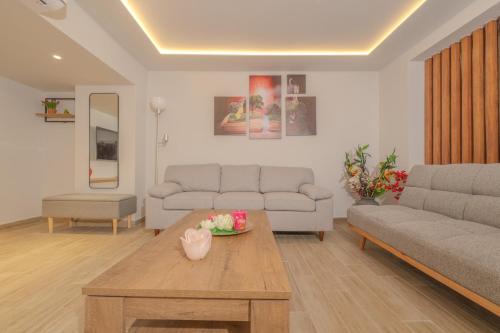 a living room with two couches and a coffee table at Fairytale Apartment in Piraeus