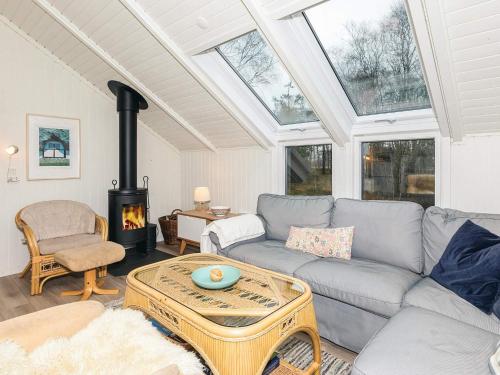 a living room with a couch and a fireplace at 6 person holiday home in Læsø in Læsø