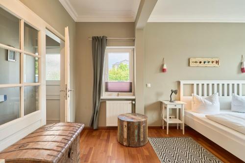 a small bedroom with a bed and a window at Haus Sonnenhof Sonnenhof 10 - Joni in Kellenhusen