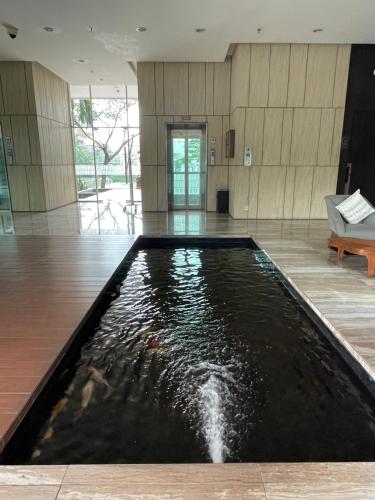 a koi pond in the middle of a room at 2BR Peaceful & Cozy Family Condo in Jakarta