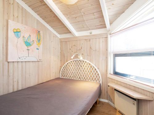 a bed in a room with a window at 8 person holiday home in Bindslev-By Traum in Bindslev