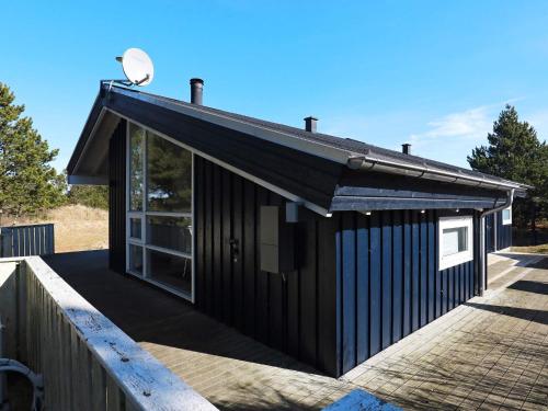 a black building with a window and a satellite at 8 person holiday home in Bindslev-By Traum in Bindslev