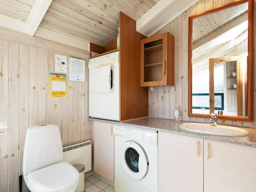 a small kitchen with a washing machine and a sink at 8 person holiday home in Bindslev-By Traum in Bindslev