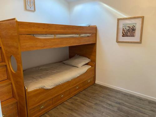 a bunk bed in a room with a bed at Maison avec jardin, à deux pas de Paris in Deuil-la-Barre