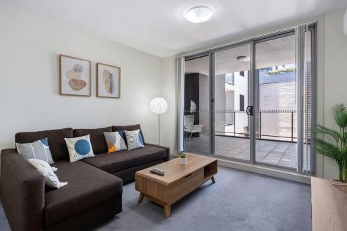 a living room with a couch and a coffee table at 38HP Abnb-Style Quality Hurlstone Park Free parking 2BR in Sydney
