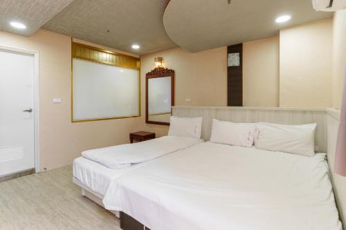 Postel nebo postele na pokoji v ubytování Love River Inn 愛河日央