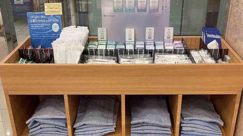 a store shelf with towels and other products on it at Toyoko Inn JR Yokohama sen Sagamihara Ekimae in Sagamihara