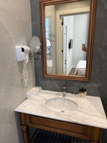 a bathroom with a sink and a mirror at Nizami Hostel in Baku