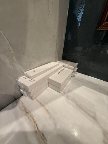 two white boxes sitting on top of a marble floor at Nizami Hostel in Baku