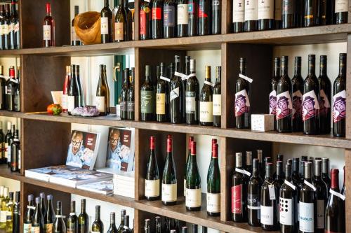 a bunch of wine bottles on shelves in a store at Malerwinkl Restaurant + Kunsthotel in Hatzendorf