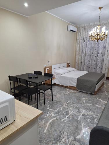 a bedroom with a bed and a table and a dining room at Arte Mia suite in Reggio Calabria