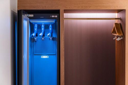 a blue refrigerator in a room with a closet at Yongin IPPDA Petite in Yongin