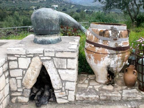 a stone oven with a bell and a pot at Cottage in Pasalites near Mount Psiloritis in Pasalítai
