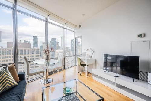 a living room with a couch and a tv at 1BR High Floor View Downtown Toronto in Toronto