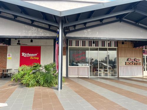 a store front with a red sign on the front at Serenity Luna Suite at M Luna KL in Kuala Lumpur