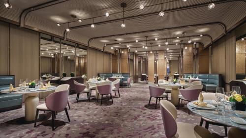 a rendering of a restaurant with tables and chairs at Crowne Plaza Hangzhou Riverside by IHG in Hangzhou