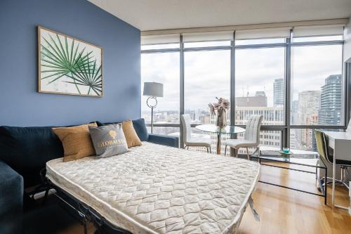 a bedroom with a bed and a table with chairs at 1BR High Floor View Downtown Toronto in Toronto
