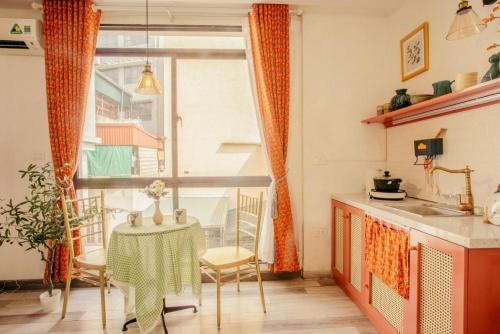 a small kitchen with a table and a window at Langmandi Experience Nhà Thờ in Hanoi