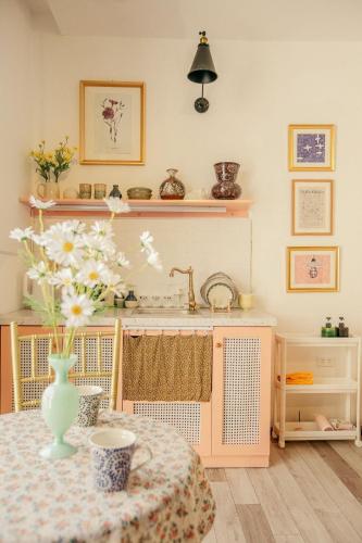 a kitchen with a table with a vase on it at Langmandi Experience Nhà Thờ in Hanoi