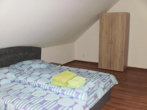 a bedroom with a bed and a wooden cabinet at Apartmány Eva Frymburk in Frymburk