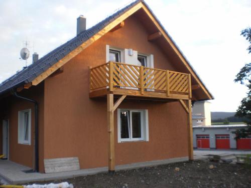 a house with a deck on the side of it at Apartmány Eva Frymburk in Frymburk