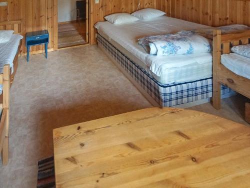 a bedroom with two beds and a wooden floor at 6 person holiday home in TORSBY-By Traum in Överbyn