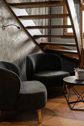 a living room with two chairs and a table at Naturhof eibl in Grossarl