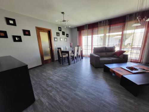 a living room with a couch and a table at Apartemento Cerveira in Vila Nova de Cerveira