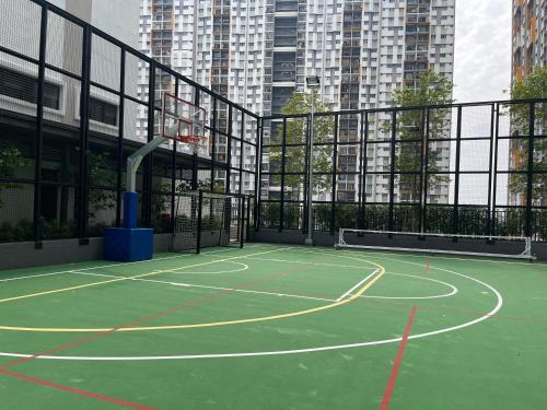 a tennis court in a city with tall buildings at Serenity Luna Suite at M Luna KL in Kuala Lumpur