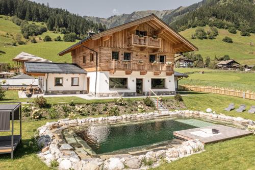 a house with a large pool in the yard at Naturhof eibl in Grossarl