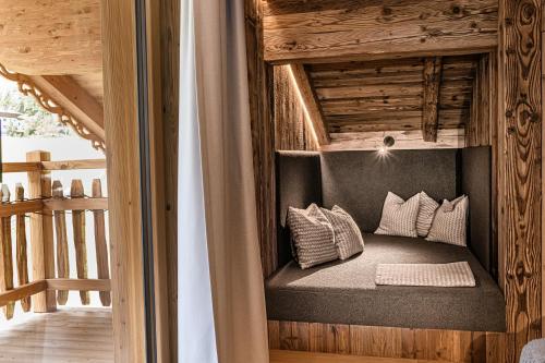 a room with a bed with pillows on it at Naturhof eibl in Grossarl