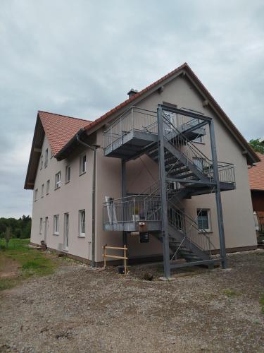 a building with a staircase on the side of it at Ferienwohnung LandZeit 2 in Schömberg