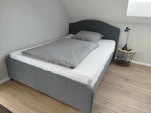 a bed in a bedroom with a white mattress at Ferienwohnung LandZeit 2 in Schömberg